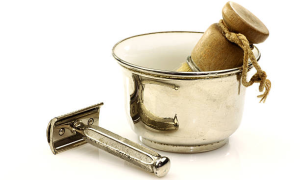 Vintage Safety Razor, brush, and metal shaving bowl on a white background.