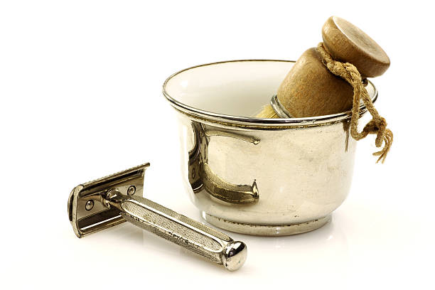 Vintage Safety Razor, brush, and metal shaving bowl on a white background.
