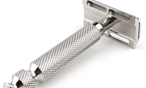 Classic stainless steel safety razor with textured grip.